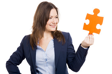 Image showing Business woman holding a puzzle piece