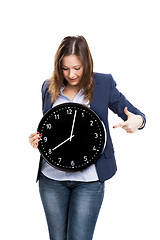 Image showing Business woman holding a big clock