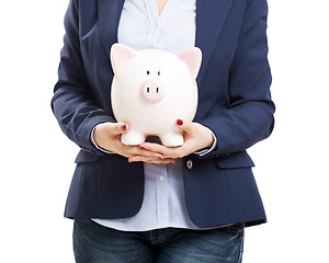 Image showing Business woman with a piggy bank