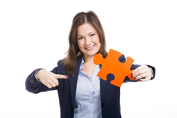 Image showing Business woman holding a puzzle piece