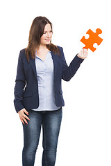 Image showing Business woman holding a puzzle piece