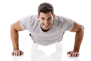 Image showing Handsome young man making pushups