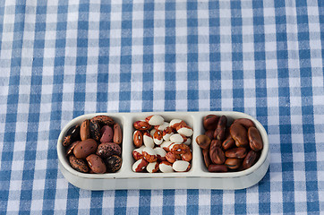 Image showing close up of beans three pieces plate on tablecloth 