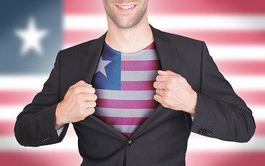 Image showing Businessman opening suit to reveal shirt with flag