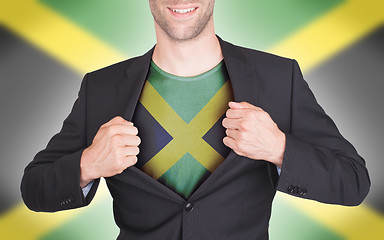 Image showing Businessman opening suit to reveal shirt with flag