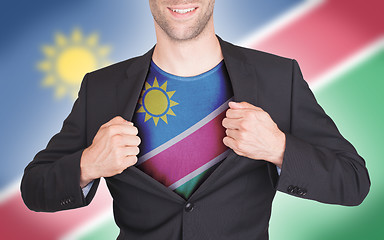 Image showing Businessman opening suit to reveal shirt with flag