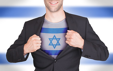 Image showing Businessman opening suit to reveal shirt with flag