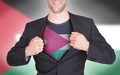 Image showing Businessman opening suit to reveal shirt with flag