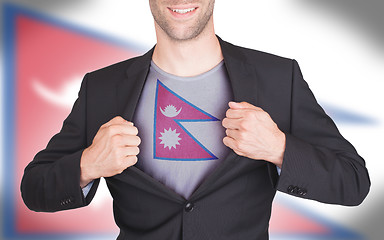 Image showing Businessman opening suit to reveal shirt with flag