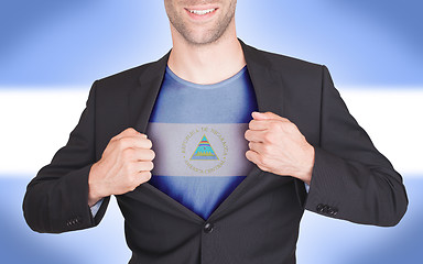 Image showing Businessman opening suit to reveal shirt with flag