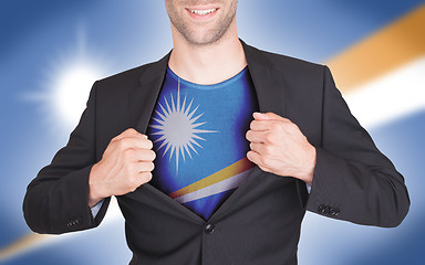 Image showing Businessman opening suit to reveal shirt with flag