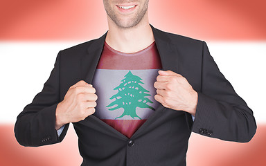 Image showing Businessman opening suit to reveal shirt with flag