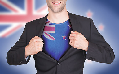 Image showing Businessman opening suit to reveal shirt with flag