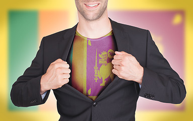 Image showing Businessman opening suit to reveal shirt with flag