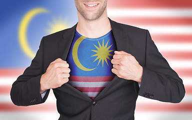 Image showing Businessman opening suit to reveal shirt with flag