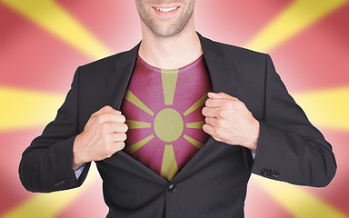 Image showing Businessman opening suit to reveal shirt with flag