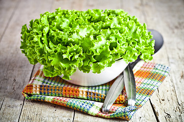 Image showing lettuce salad in a bowl and spoons 