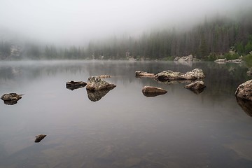 Image showing Rocks reflected in a foggy lake