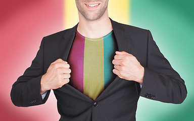 Image showing Businessman opening suit to reveal shirt with flag