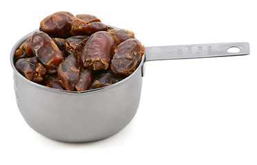 Image showing Sticky whole dates in an American cup measure