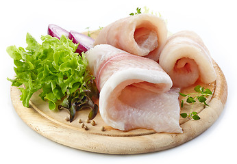 Image showing raw fish fillets on wooden cutting board