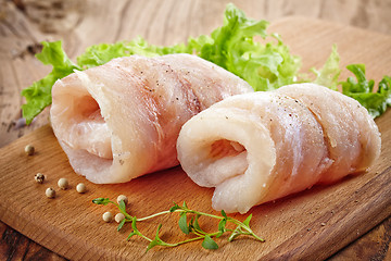 Image showing raw hake fish fillet rolls