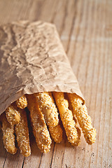 Image showing bread sticks grissini with sesame seeds in craft pack