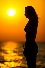 Image showing Young woman silhouette at sunset