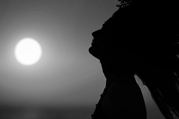 Image showing Young woman at sunset black and white