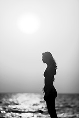 Image showing Woman silhouette at sunset black and white