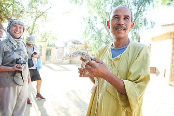 Image showing Man holding desert monitor in Tozeur Zoo