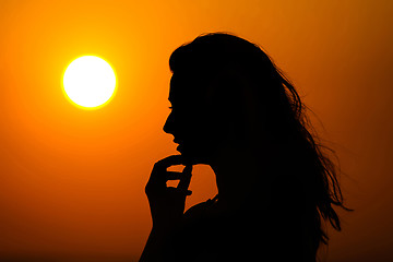 Image showing Woman enjoying sunset