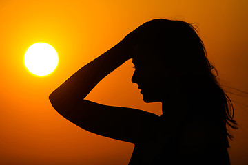 Image showing Woman silhouette on sunset