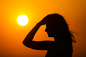 Image showing Woman enjoying sunset