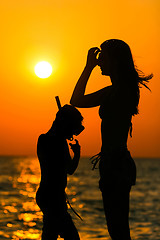 Image showing Silhouette of people at sunset