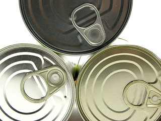 Image showing Three  lying tin cans on a white background