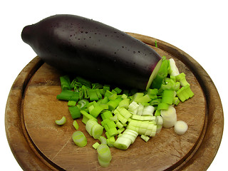 Image showing Eggplant and cutted  spring onion on wooden plate 