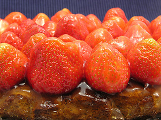 Image showing Lateral close-up view of a strawberry cake on blue background