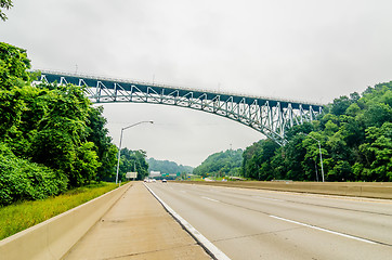 Image showing steel bridge over highway on cloudy day in the mountains