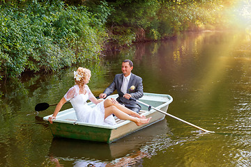 Image showing Young just married bride and groom on boat