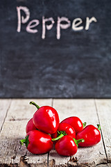 Image showing red hot peppers and blackboard