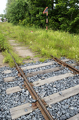 Image showing old rusty rails, sleepers and grass