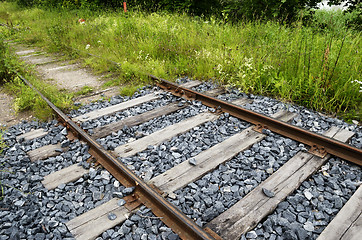 Image showing old rusty rails, sleepers and grass