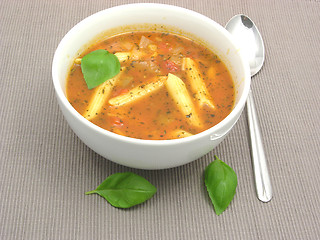 Image showing Noodle soup with tomatoes and herbs on gray