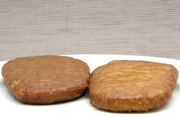 Image showing Two breaded bean curd cutlets on a white plate