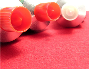 Image showing Three sealed tubes on a red placemat