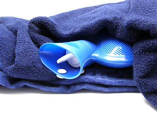 Image showing Blue hot-water bag wrapped in a blue blanket on a  white background