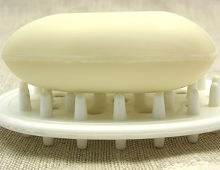 Image showing Beige soap on a soap dish on a beige background