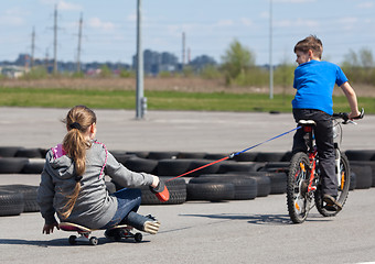 Image showing Cyclist and skateboarder