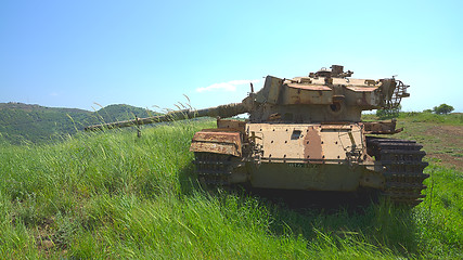 Image showing Destroyed rusty tank on battlefield near the border